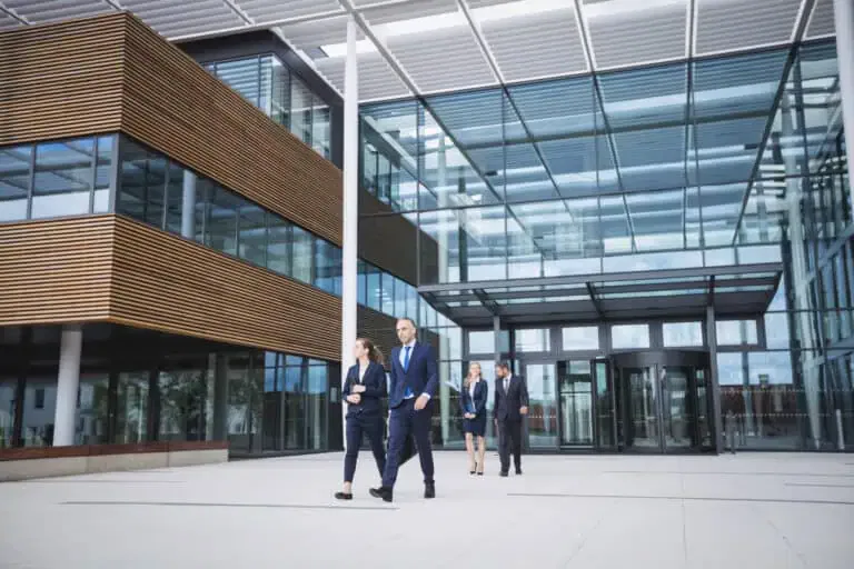 business people walking outside office building