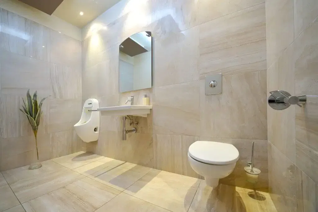 Spacious, accessible residential bathroom with ADA-compliant wall-mounted toilet and sink in California