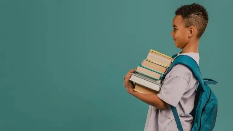side view child holding pile books copy space 23 2148764072