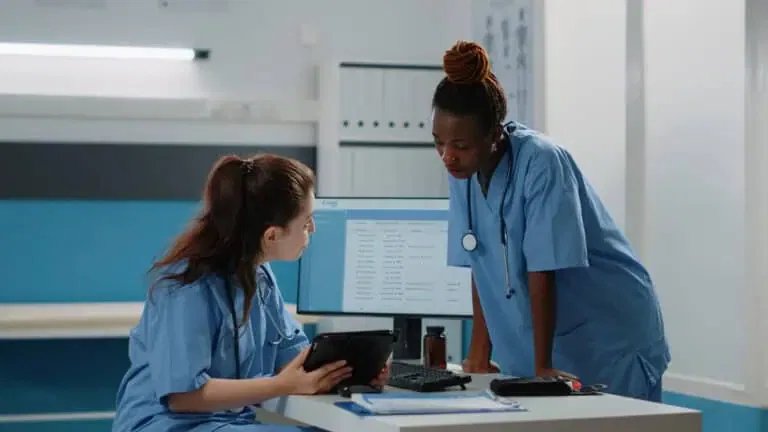 multi ethnic team nurses looking digital tablet consultation treatment diverse group medical assistants working with technology healthcare system checkup