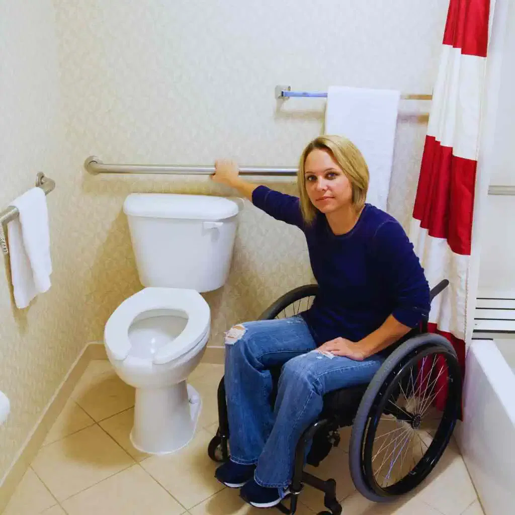 Wheelchair User Demonstrating Accessible Toilet Transfer and Grab Bar Placement
