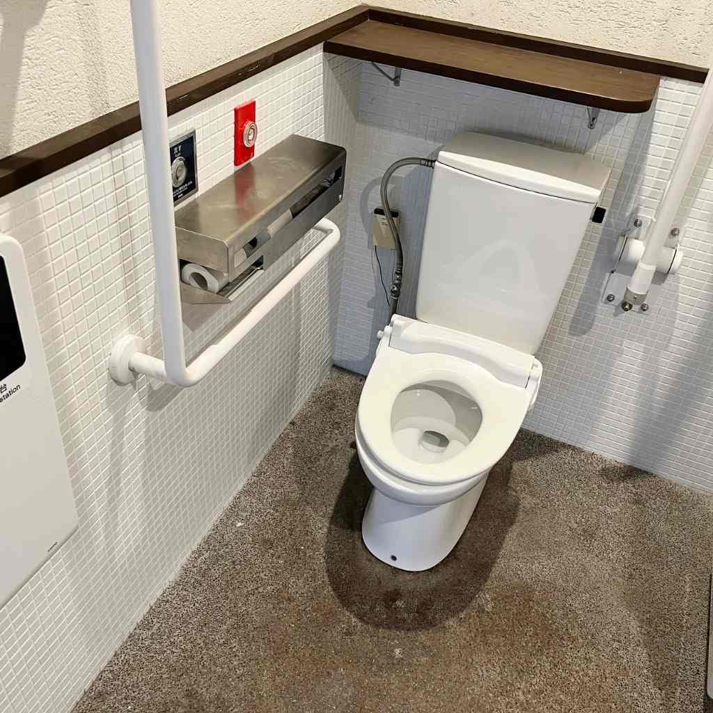 Clear floor space next to an accessible toilet showing required 60-inch clearance in a commercial restroom