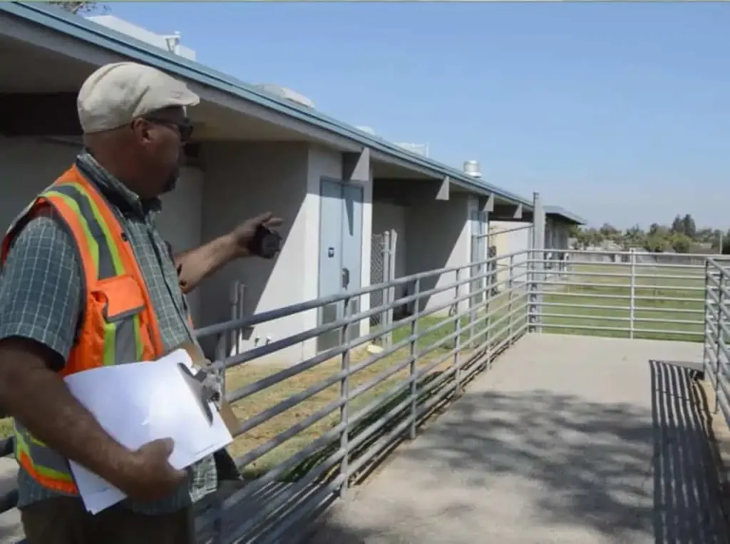ada inspector reviewing school handicap ramp