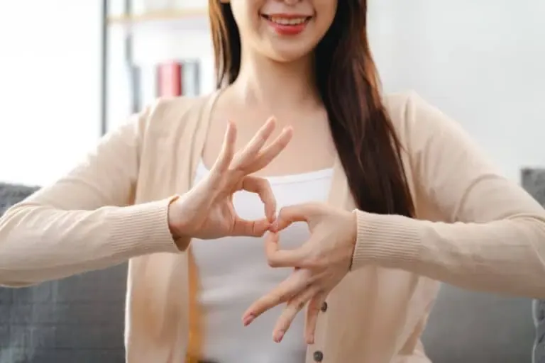 vecteezy a young deaf woman is sitting on a couch and making a sign 45695169 1