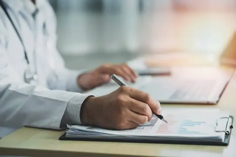 vecteezy doctor working with chart paper and laptop computer looking 6697115 1