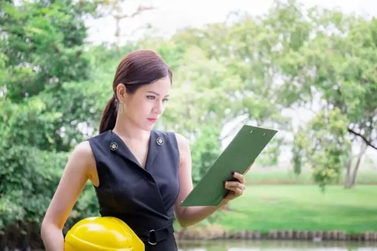vecteezy young woman holding hardhat and looking at clipboard 7708700 1