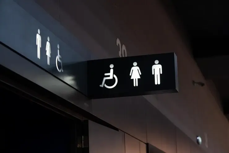 sign restroom lighten white standout from black plate restroom is inside building decorated black white tone 39476 5559