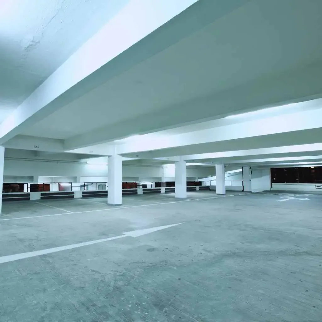 Spacious indoor parking garage with level surfaces and marked stalls, representing accessible parking features businesses in Fresno must address post-ADA lawsuit